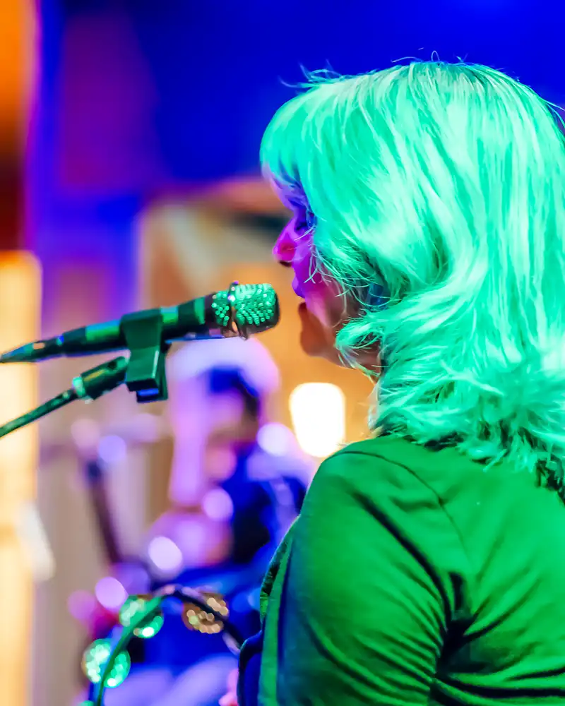 Singer performing live on stage at Island Oaks