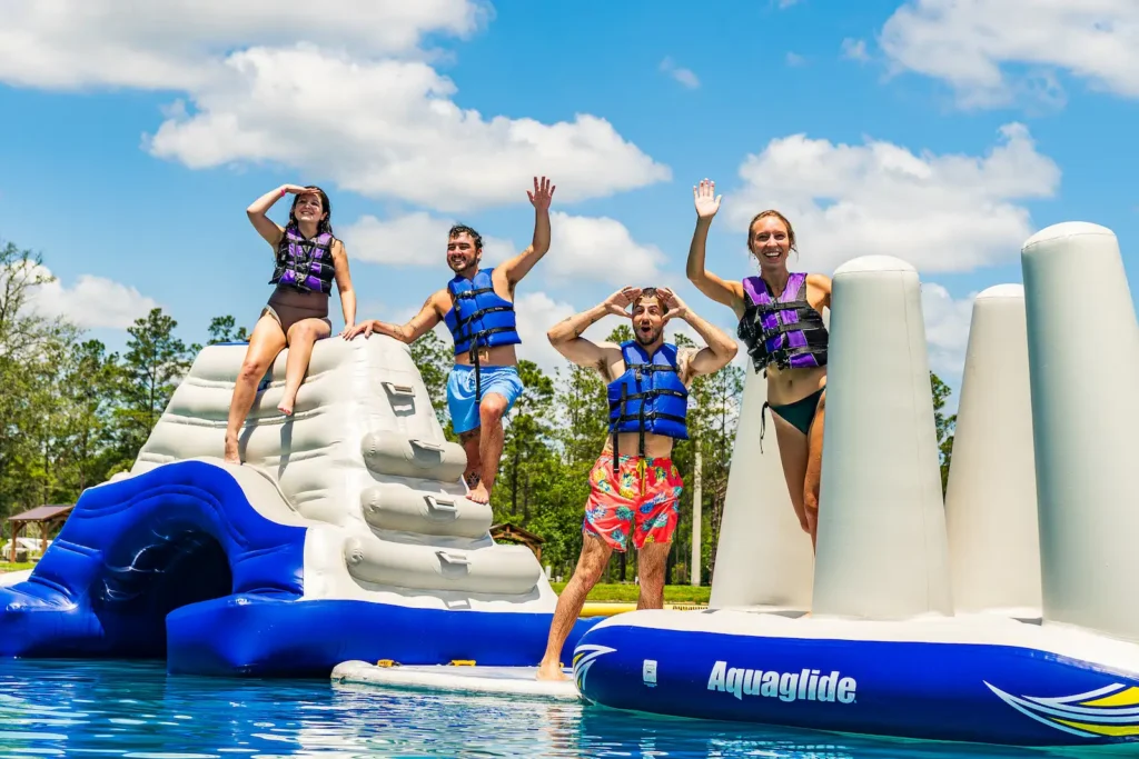 Island Oaks guests waving on the inflatable obstacle course