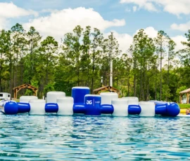 Island Oaks guests on the inflatable obstacle course in the Swimming Lake