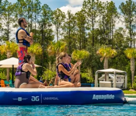 Adults clapping on the Island Oaks inflatable obstacle course