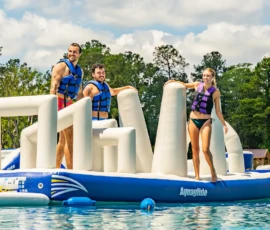 Three Island Oaks guests on the inflatable obstacle course in the Swimming Lake