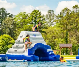 Kids climbing on the Island Oaks inflatable obstacle course