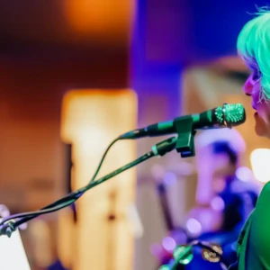 Woman singing and performing live on stage at Island Oaks