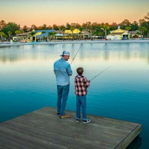Father and son fishing on the dock of the lake at Island Oaks