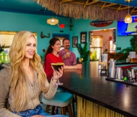 Woman holding a martini glass at The Palms bar