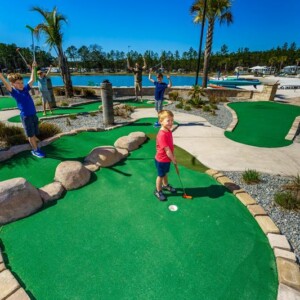 Kids playing mini golf at Island Oaks