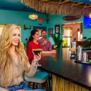 Woman holding a martini glass at The Palms bar